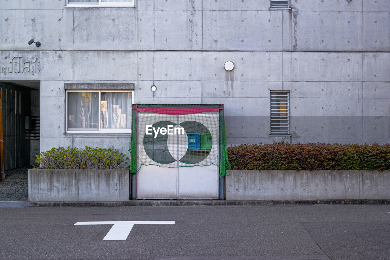 ROAD SIGN AGAINST WALL