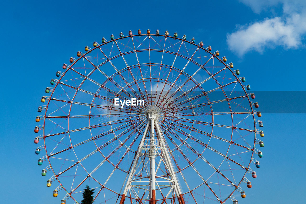 Low angle view of ferris wheel against sky