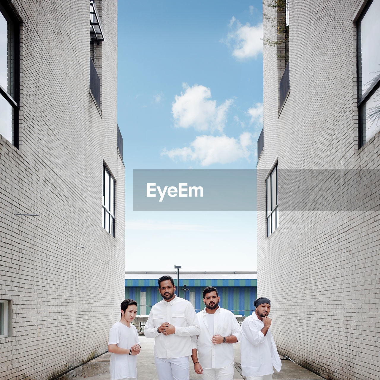 GROUP OF PEOPLE ON BUILDINGS AGAINST SKY