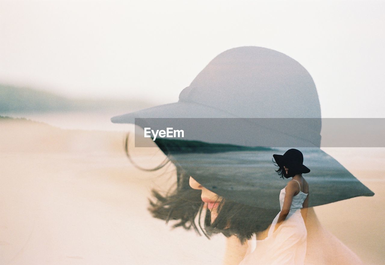 Double exposure of woman at beach