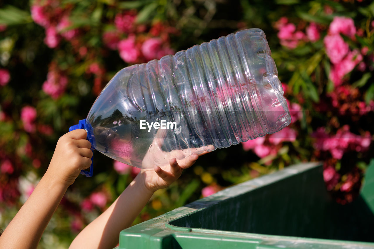 Close-up of hand holding plastic bottle