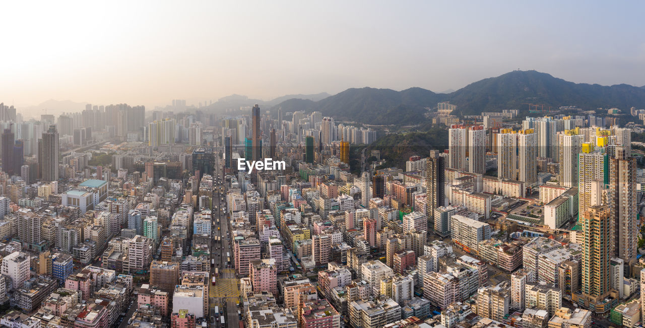 Aerial view of city and mountains against sky