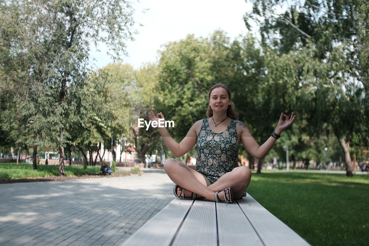 Full length of woman sitting in park