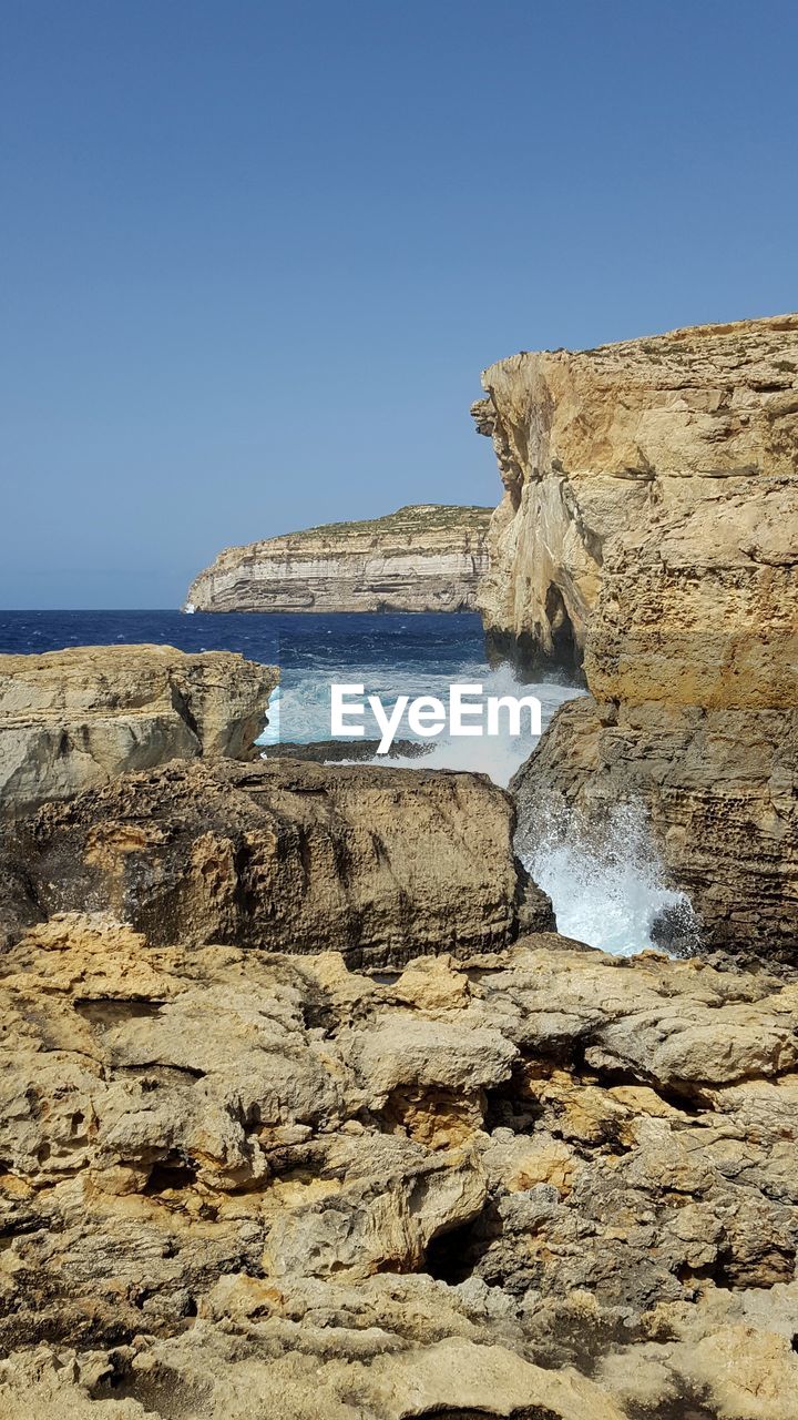 Scenic view of sea against clear blue sky