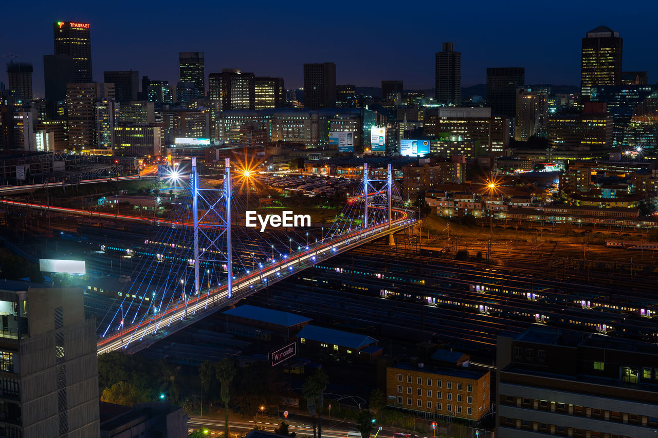 High angle view of illuminated buildings in city at night