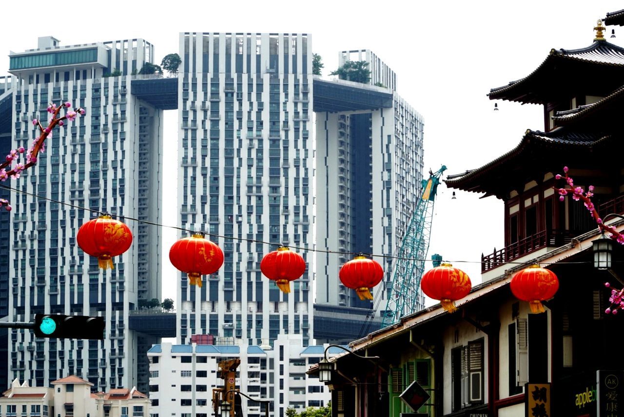 RED AND BUILDINGS AGAINST SKY