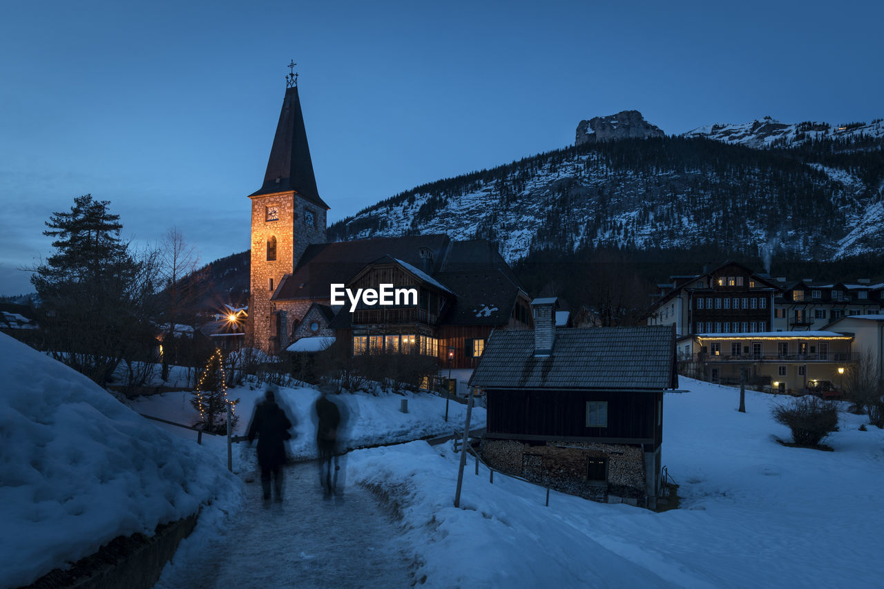 BUILDING AGAINST SKY DURING WINTER AT NIGHT