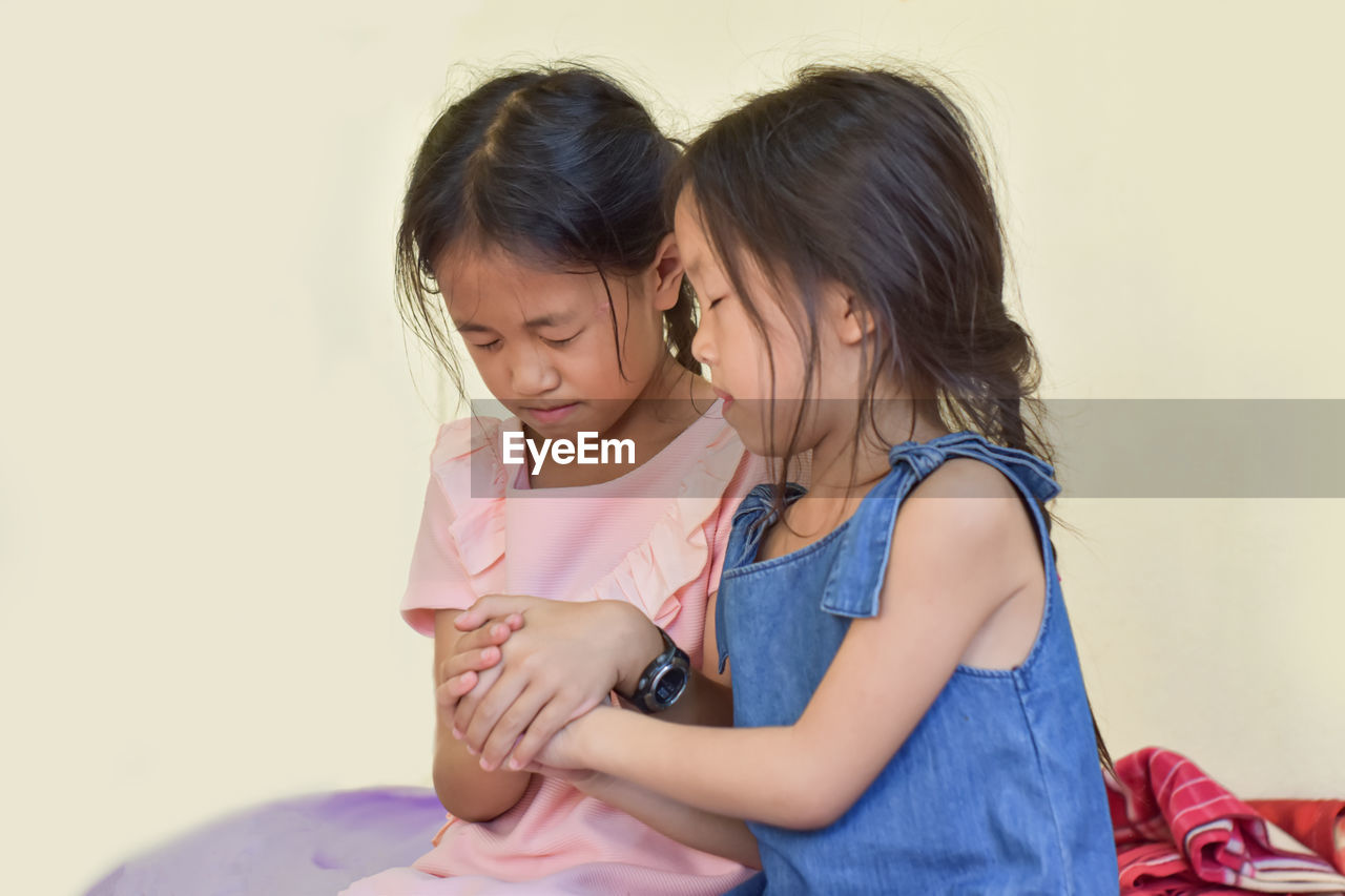 Two little girl praying, hands clasped together for blessing from god. christian for faith concept.