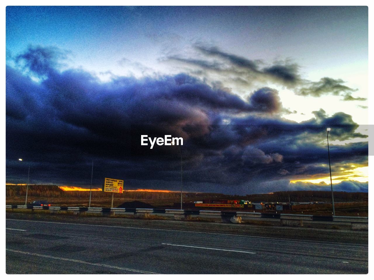 STORM CLOUDS OVER ROAD