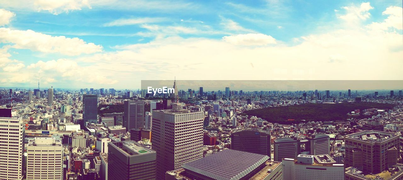 Cityscape against cloudy sky