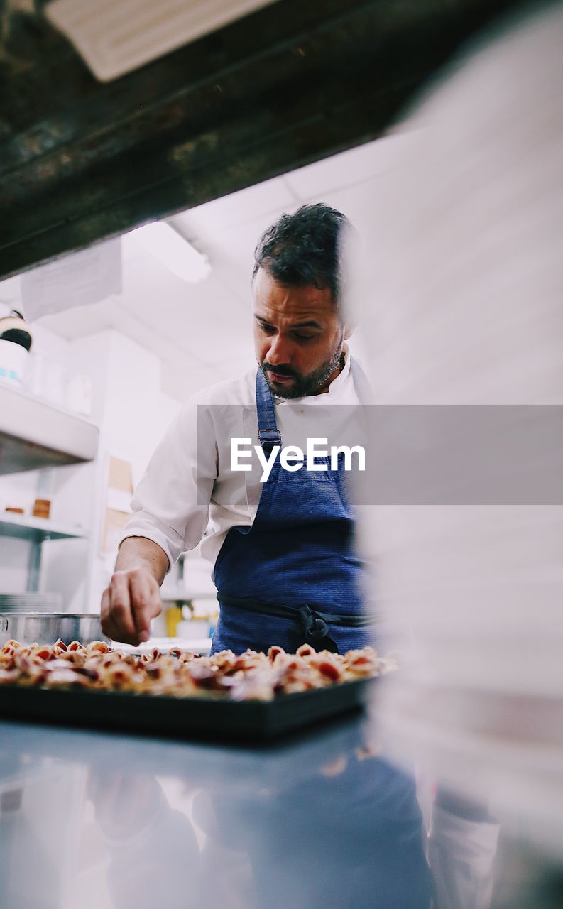 Chef garnishing food in restaurant