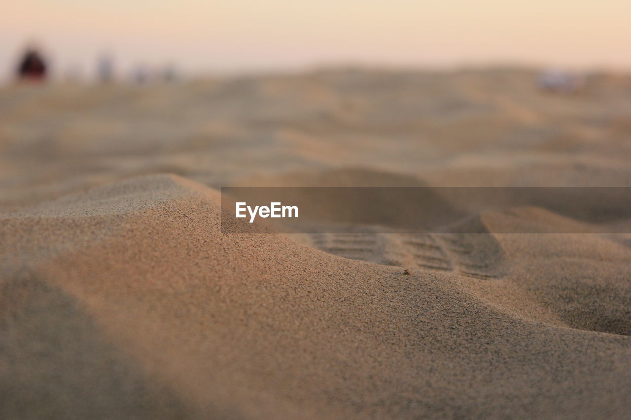 Surface level of footprint on beach during sunset