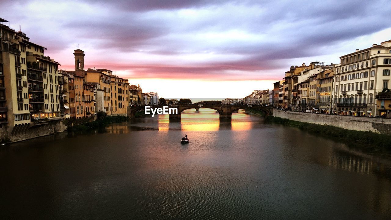 View of bridge over river against cloudy sky