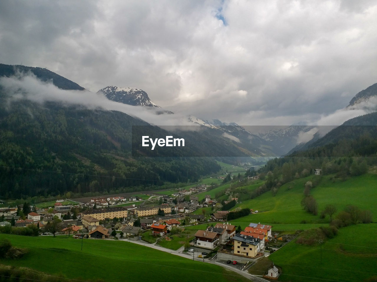 Scenic view of landscape and buildings against sky