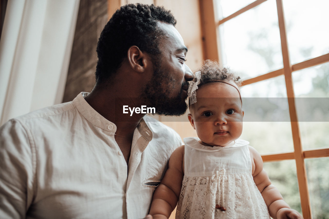 Father with baby at home