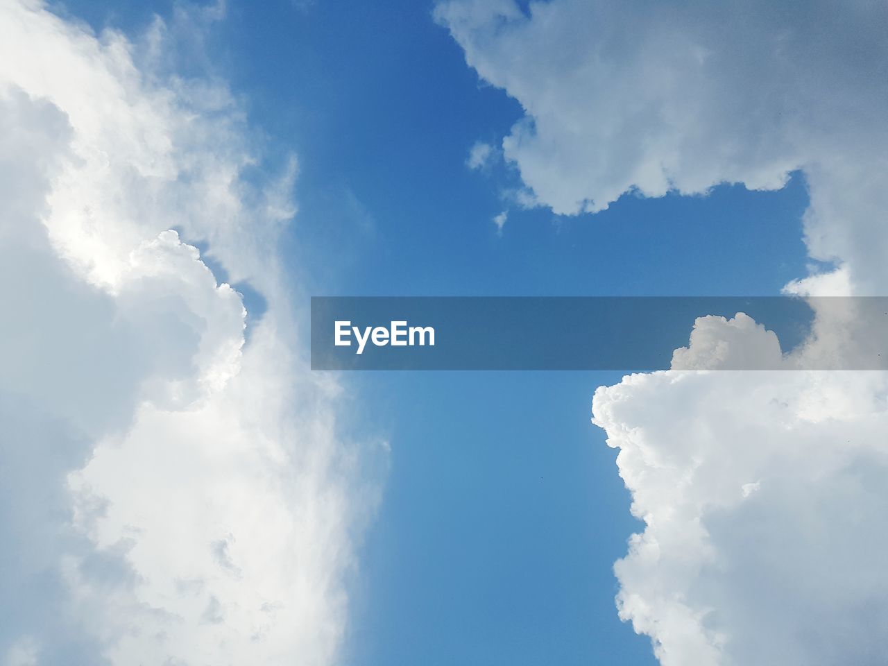 LOW ANGLE VIEW OF CLOUDS IN BLUE SKY