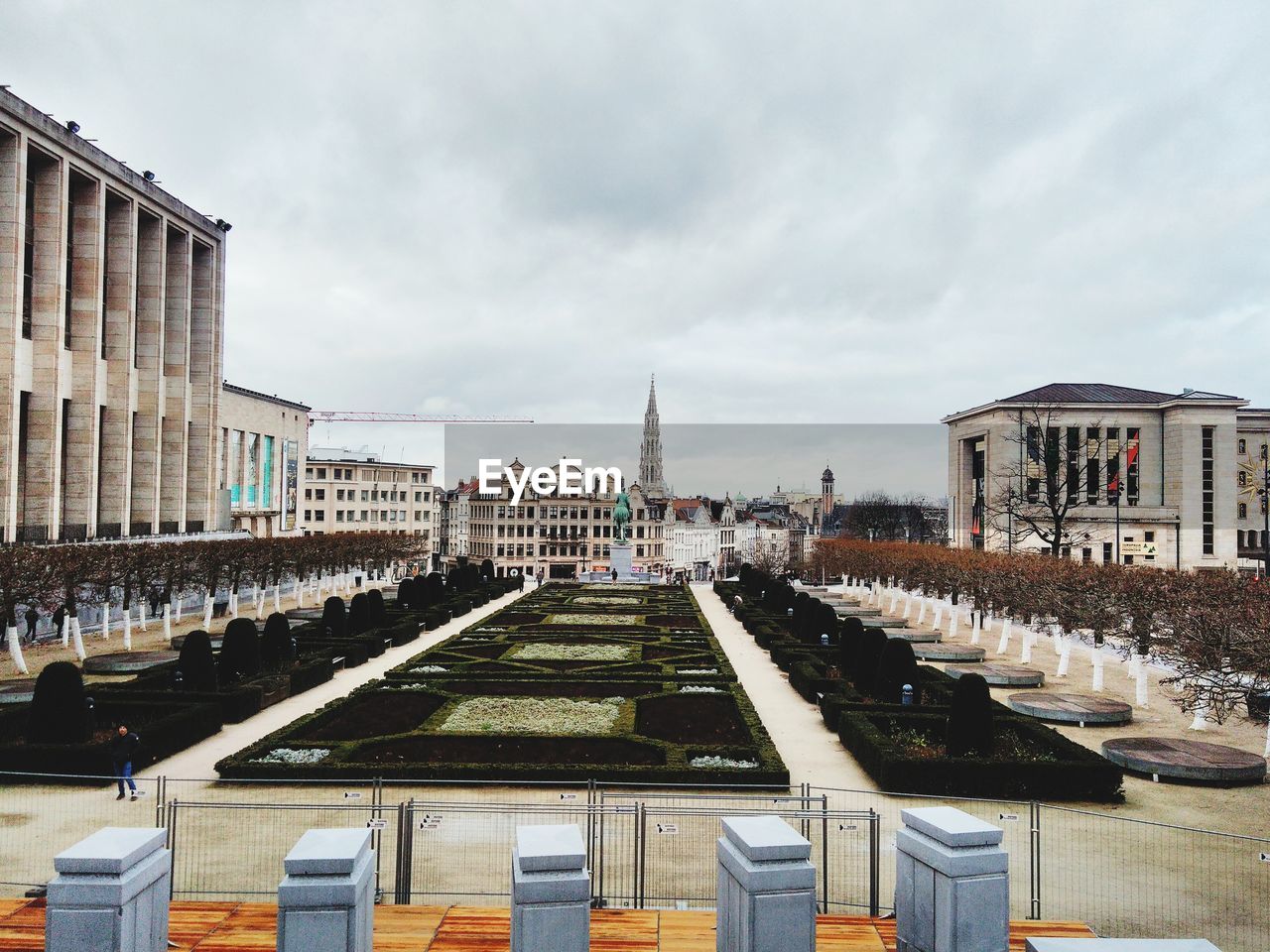 Buildings in city against cloudy sky