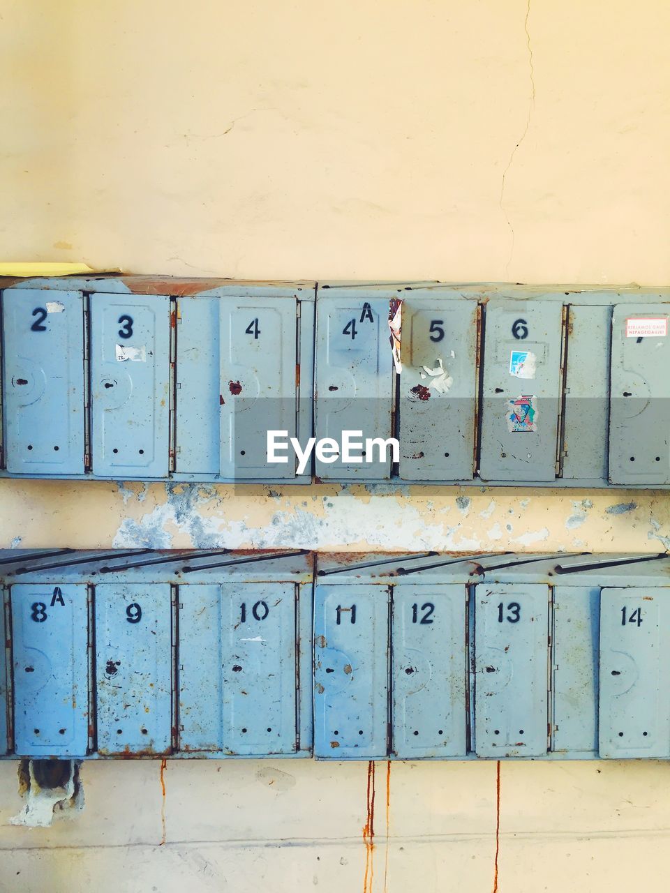 Old rusty metallic mailboxes on wall