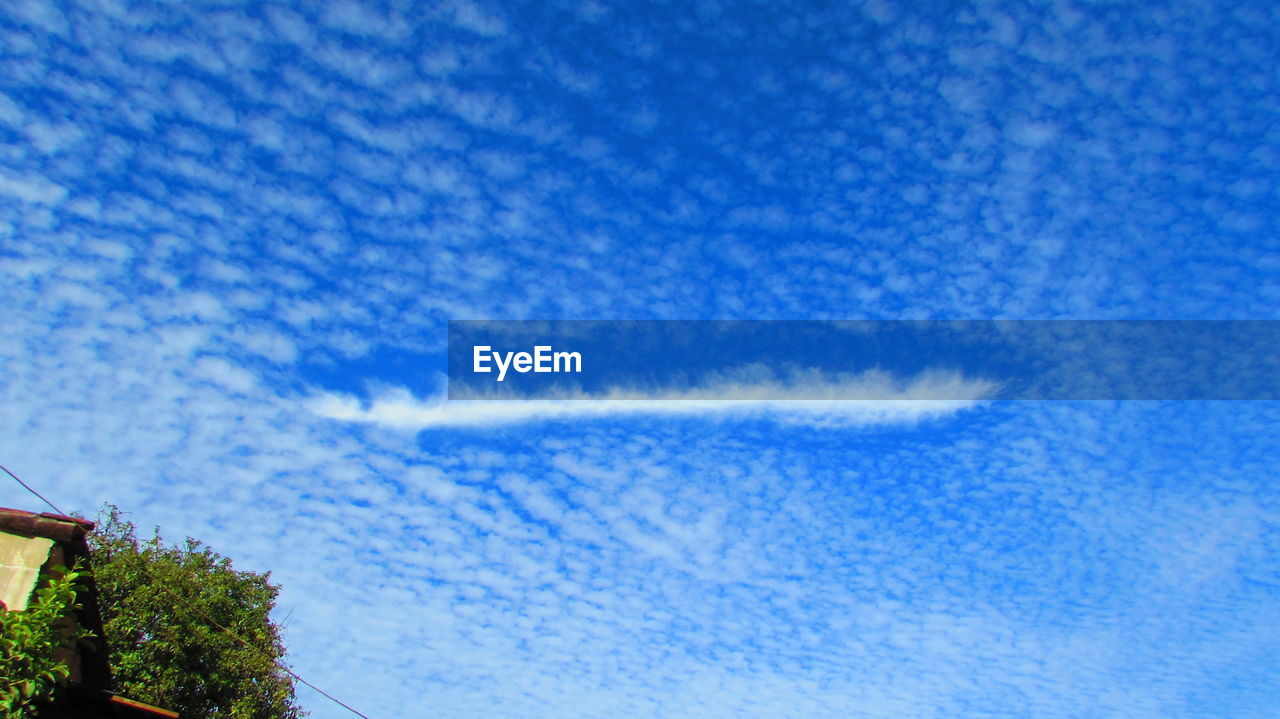 LOW ANGLE VIEW OF VAPOR TRAILS IN SKY