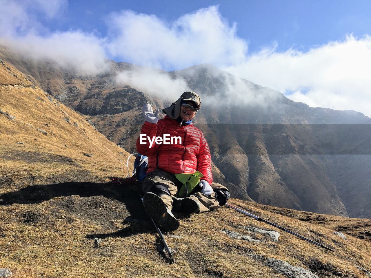 Full length of man climbing on mountain against sky