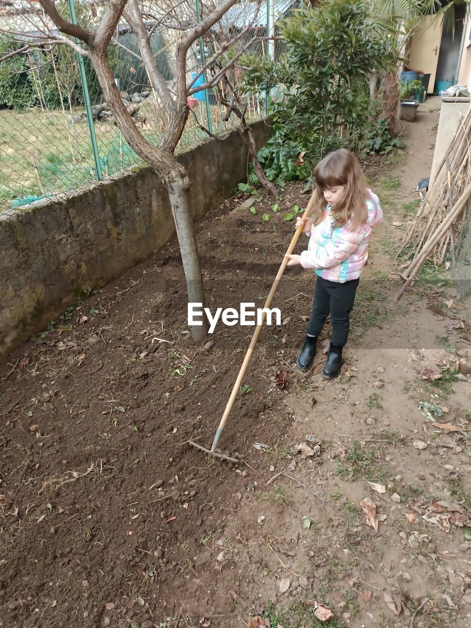 Side view of little girl working at park