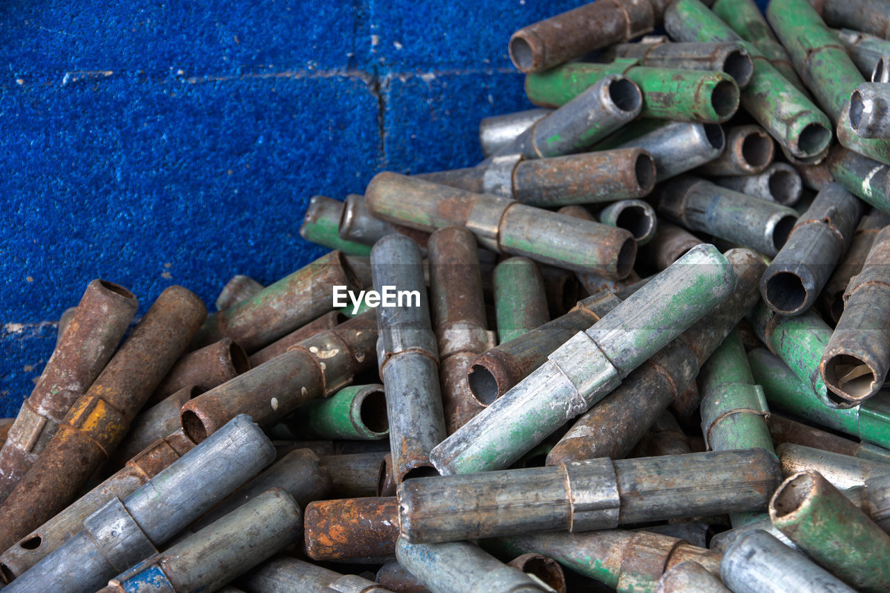 High angle view of rusty pipes against wall