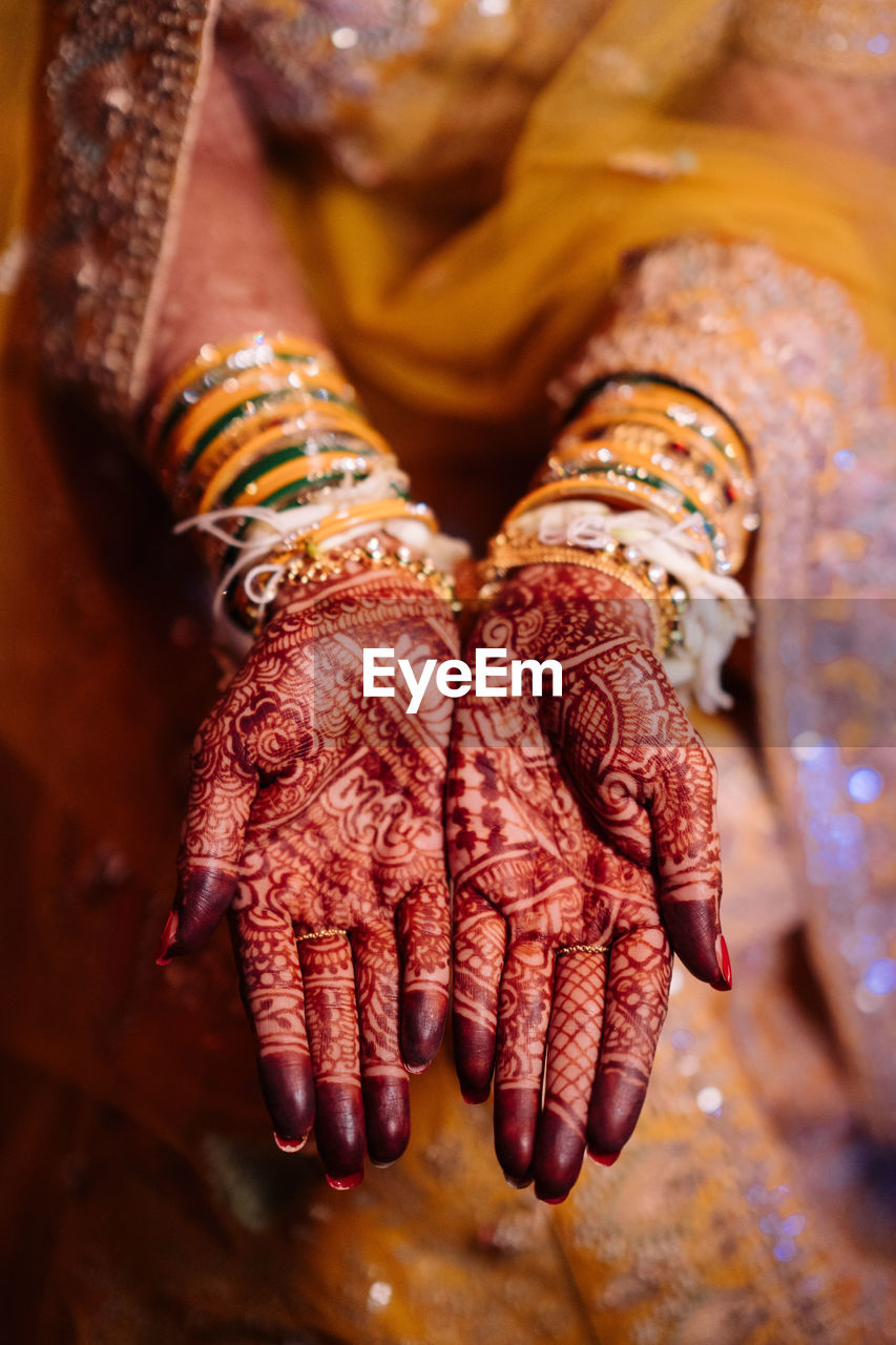 Midsection of bride with henna tattoo