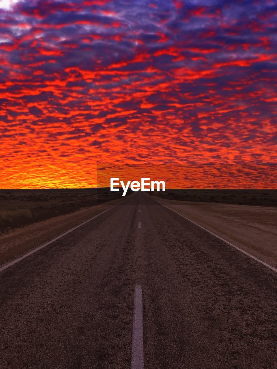 VIEW OF ROAD AGAINST CLOUDY SKY