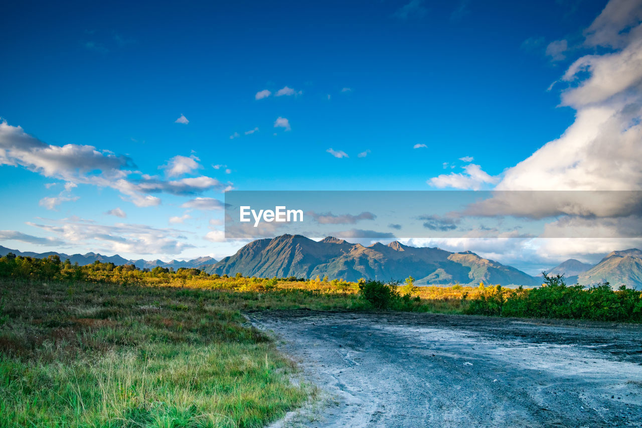 Scenic view of landscape against blue sky