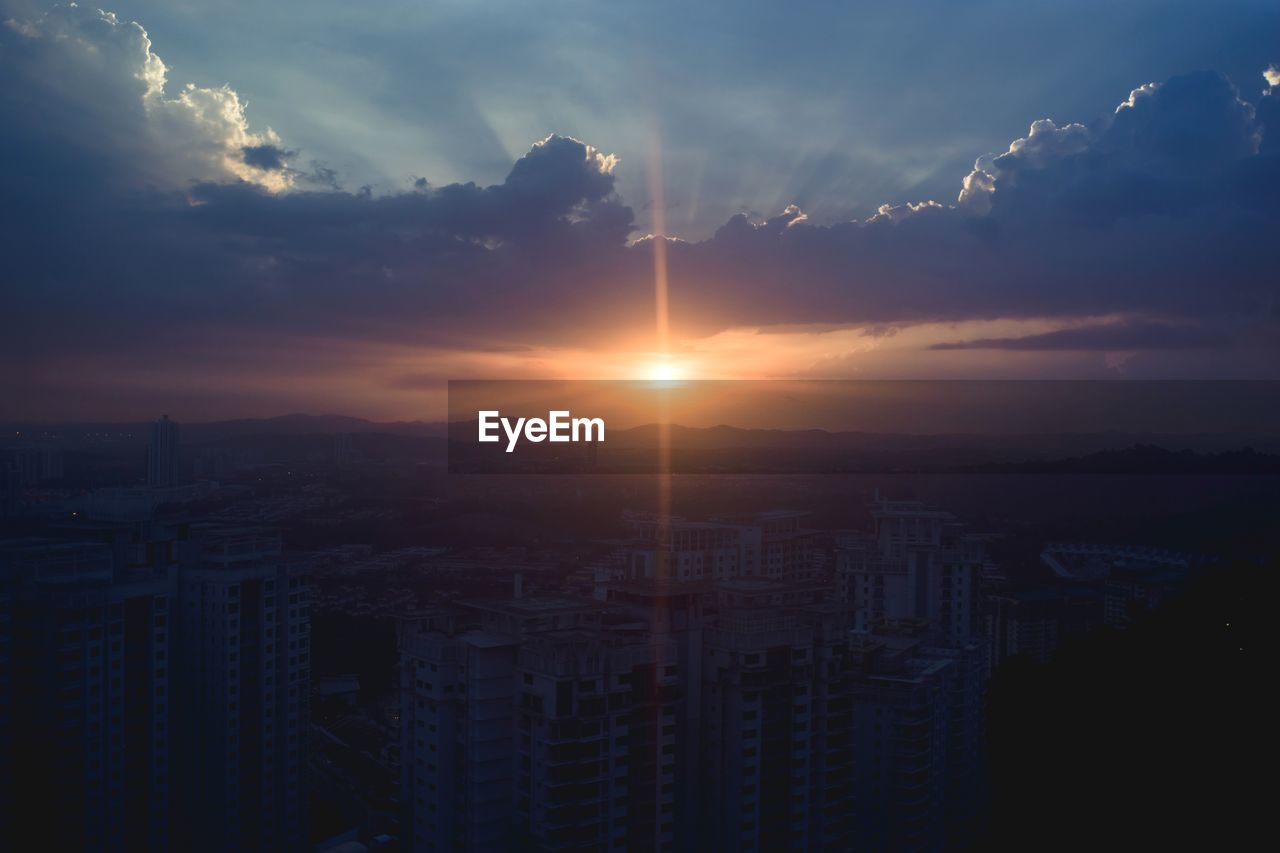 CITYSCAPE AGAINST SKY AT SUNSET