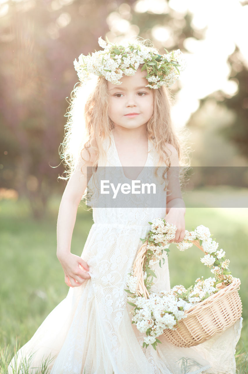 Cute girl wearing wreath at park