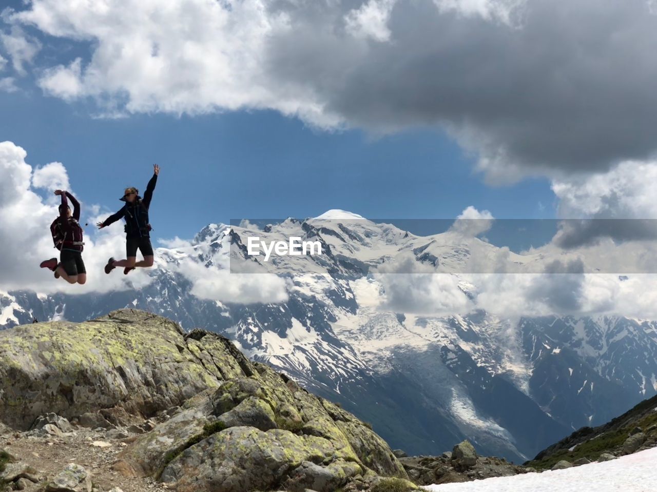 People jumping over mountain during winter