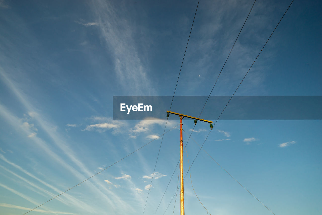 Low angle view of electric pole against sky