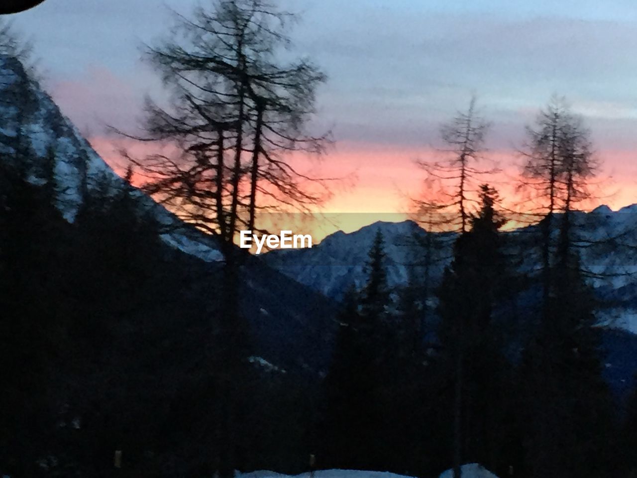 SCENIC VIEW OF SILHOUETTE MOUNTAINS DURING SUNSET