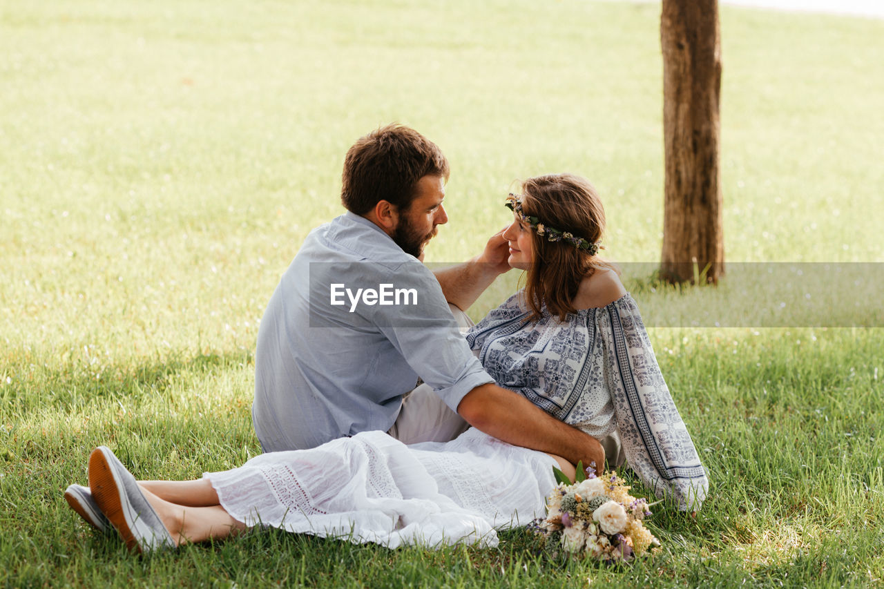 Couple sitting on grass
