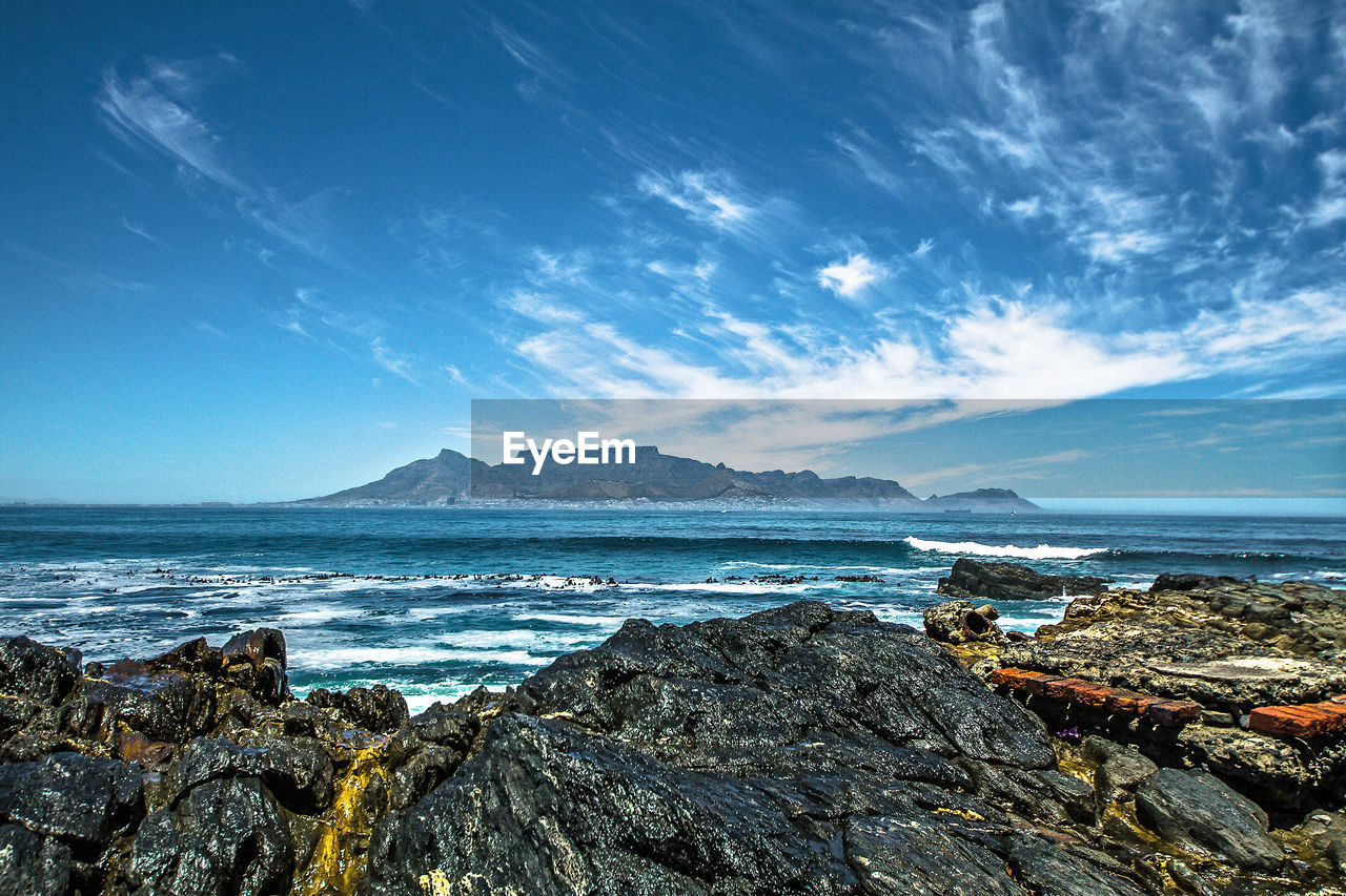 Panoramic seascape view of cape town and table mountain from remote robben island, south africa