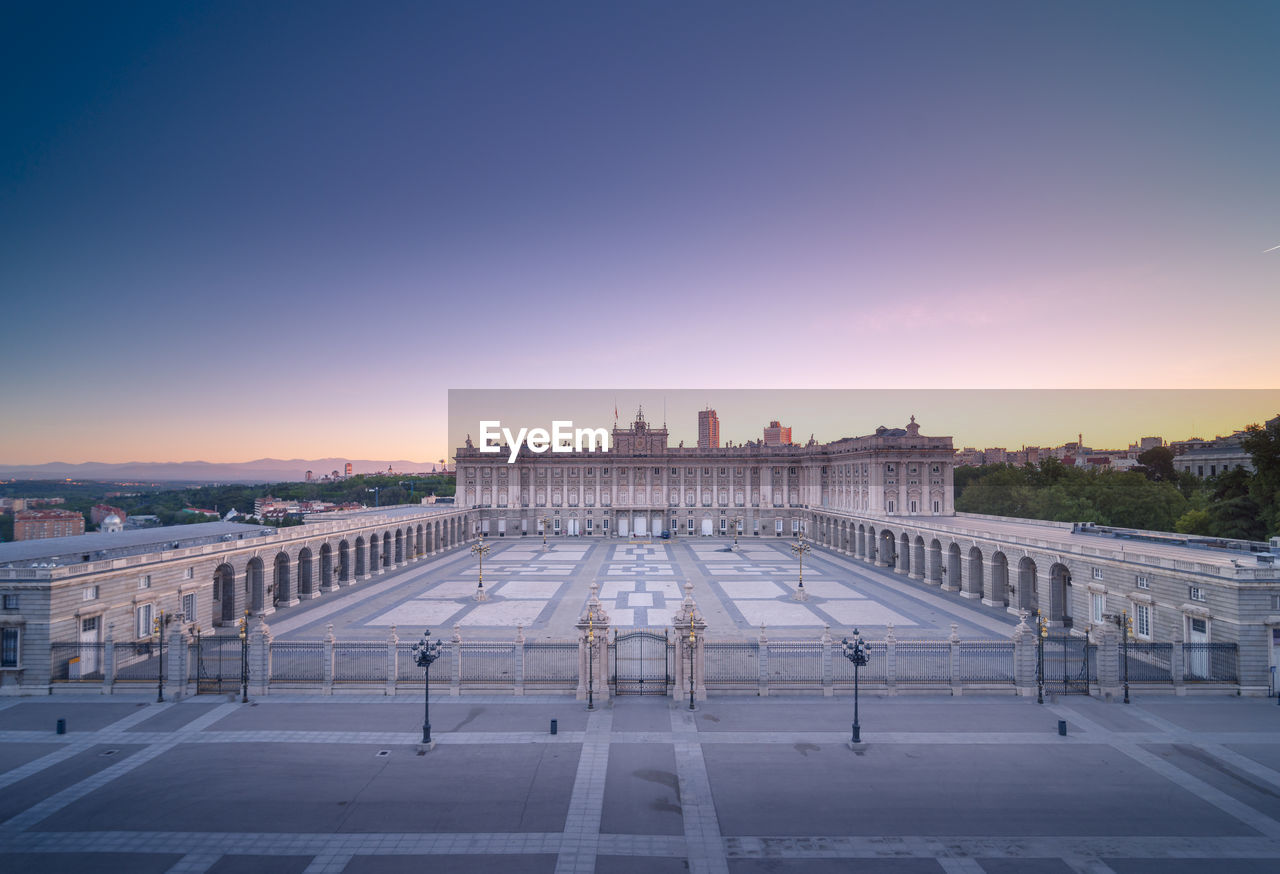 Magnificent scenery of royal palace of madrid and empty square in evening