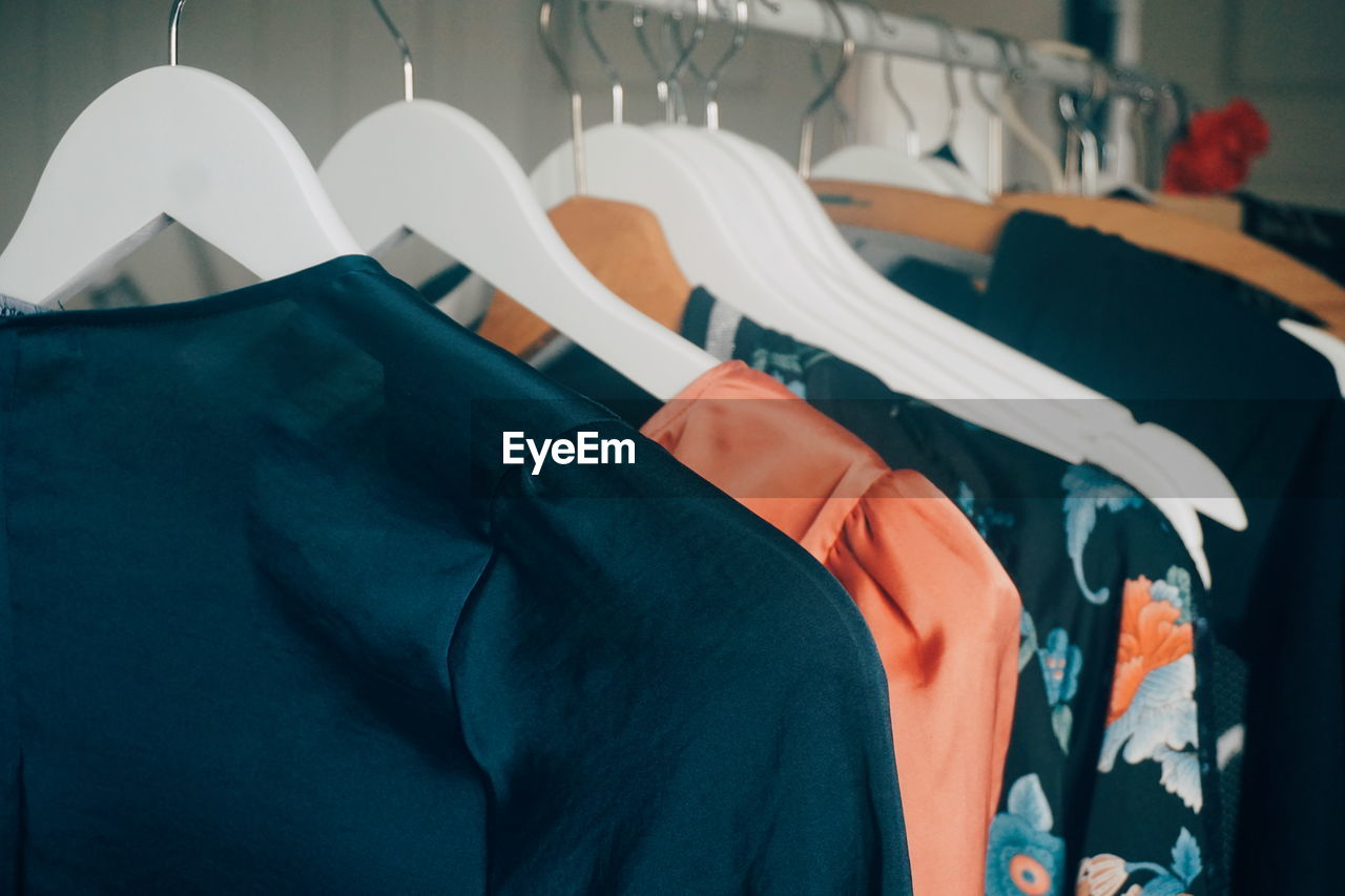 Close-up of clothes hanging on rack in store