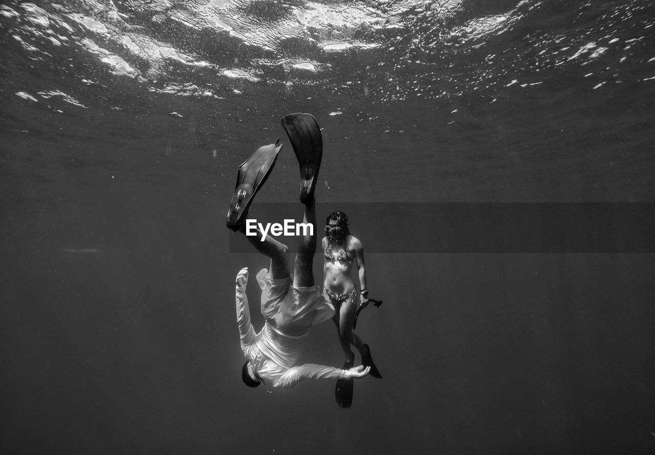 Man and woman swimming in sea