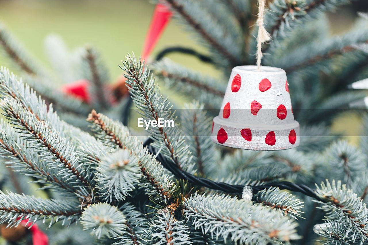 Handmade toy made of small flower pot on a christmas tree outdoor. diy decoration creative ideas for