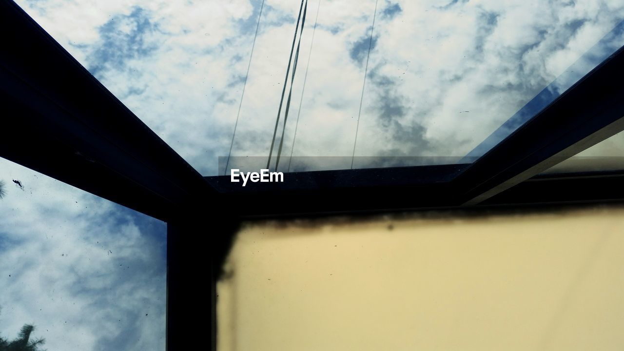 LOW ANGLE VIEW OF WINDOW AGAINST SKY