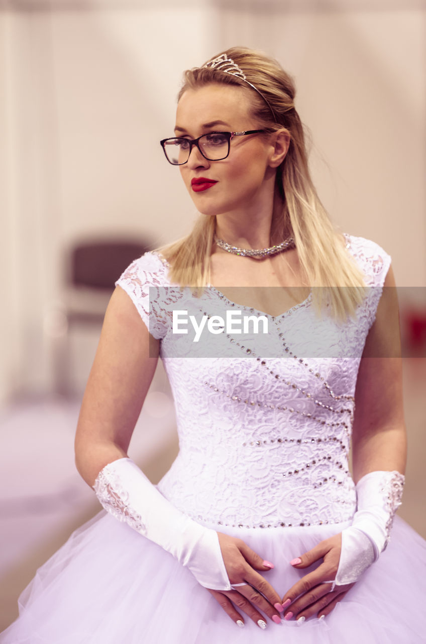 Woman in wedding dress looking away