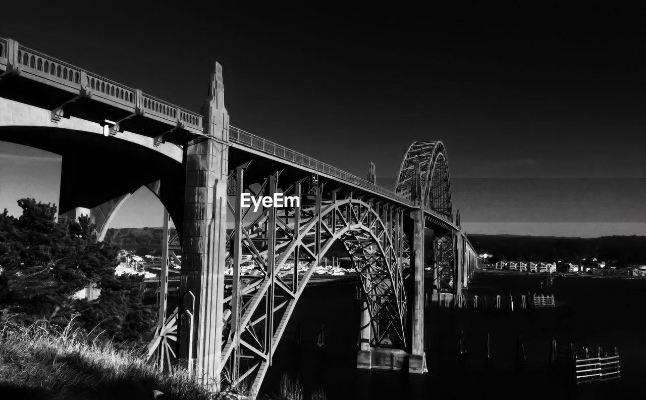 LOW ANGLE VIEW OF BRIDGE AGAINST TREES