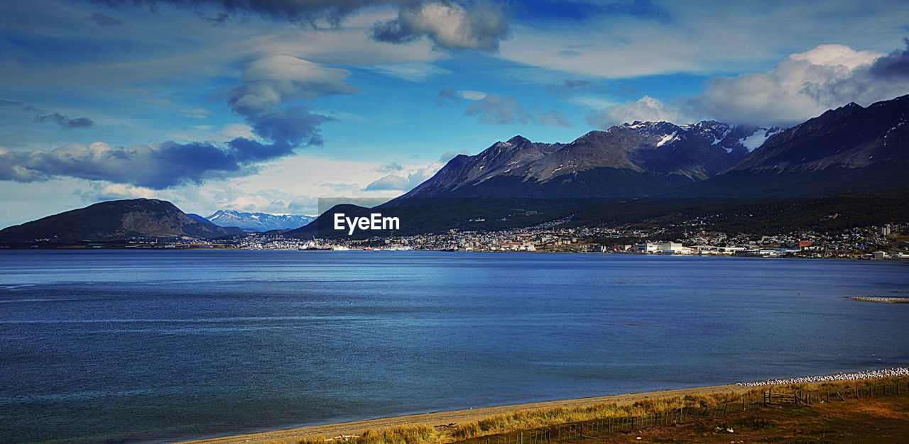 Scenic view of sea and mountains against sky