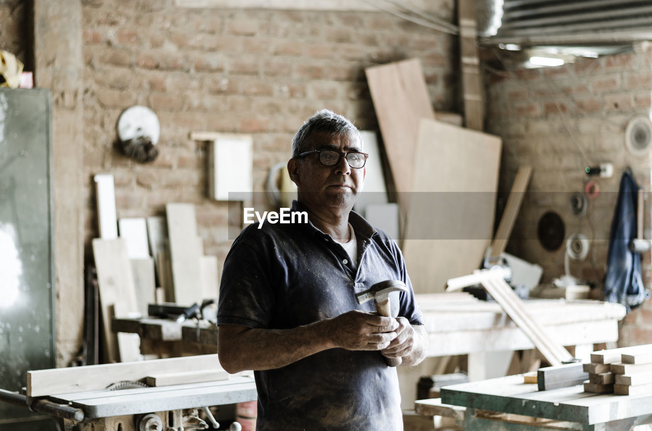 FULL LENGTH OF MAN WORKING AT TABLE