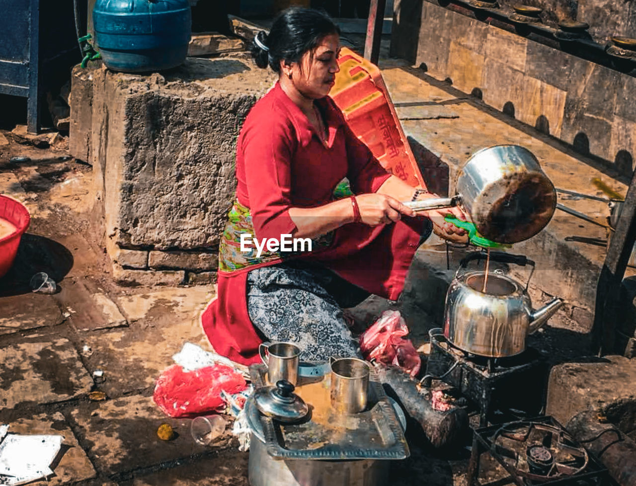 side view of man preparing food at construction site