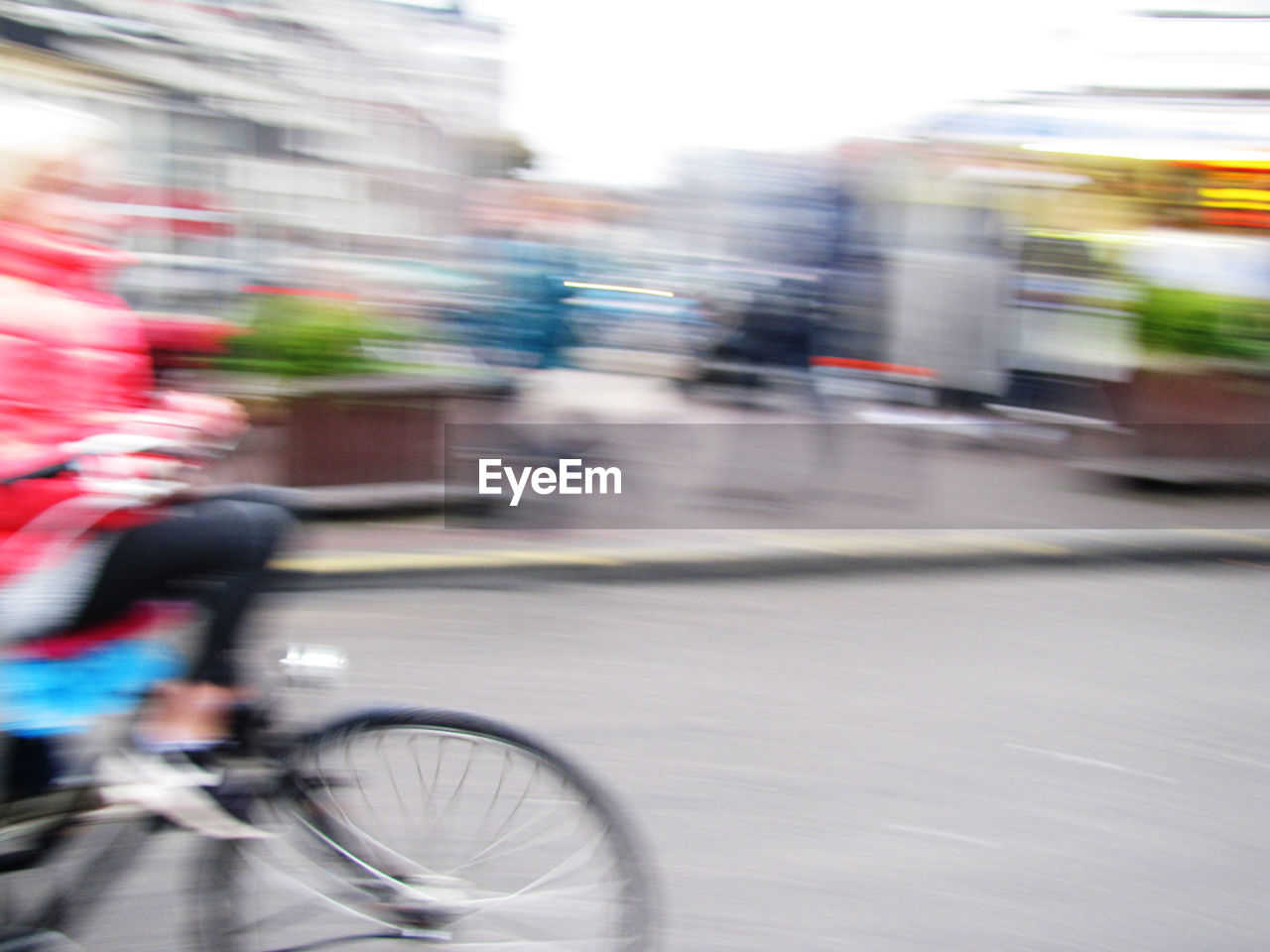 BLURRED MOTION OF PERSON RIDING BICYCLE