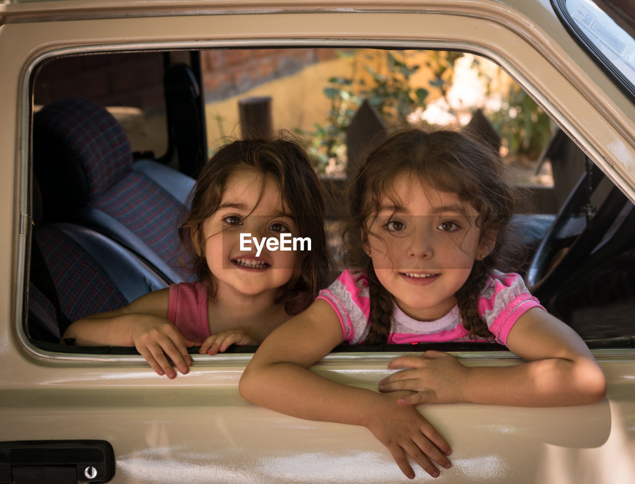 Girls smiling in a car