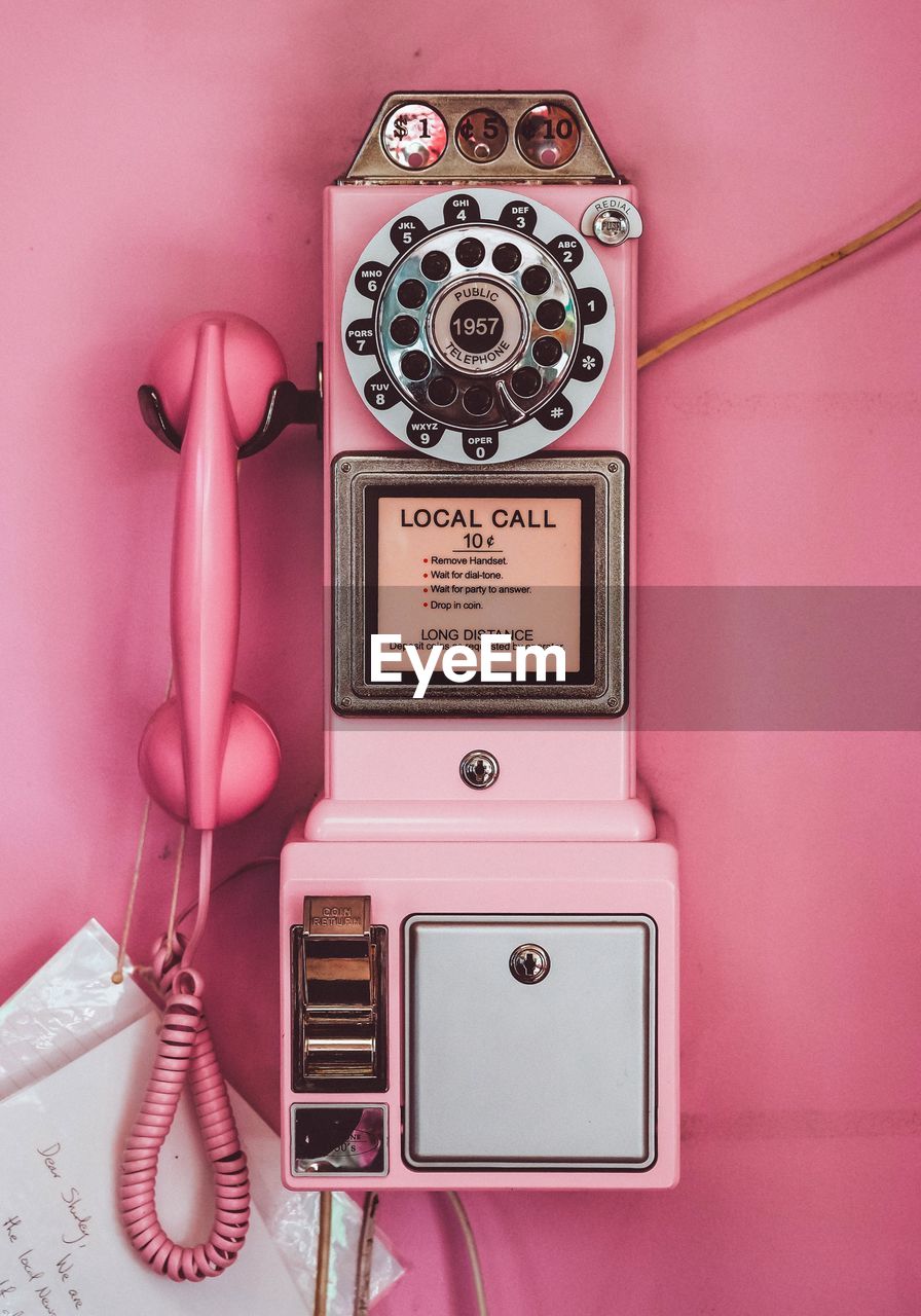 Text on pink pay phone