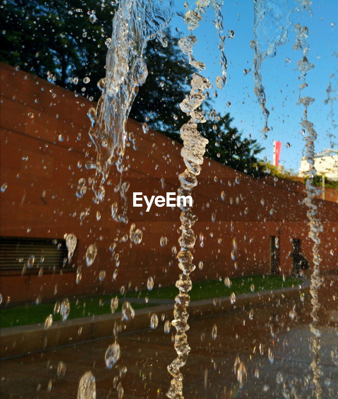 CLOSE-UP OF WATER SPLASHING AGAINST BUILDING